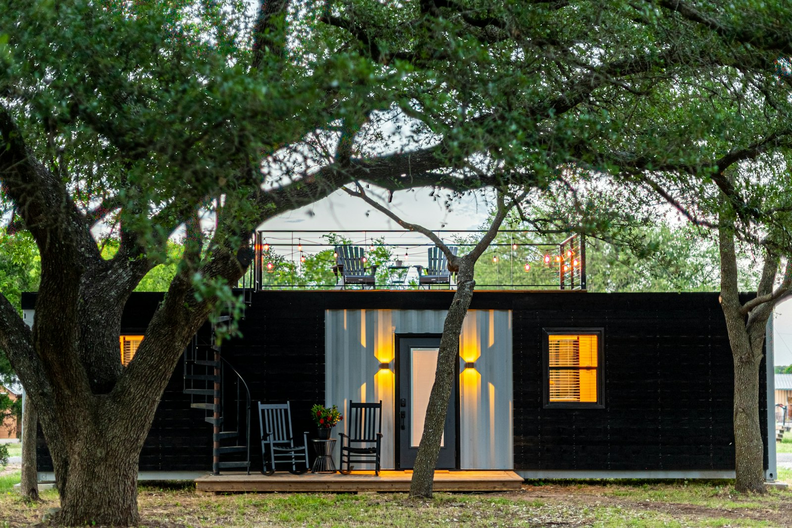 Modern shipping container home conversion with timber deck