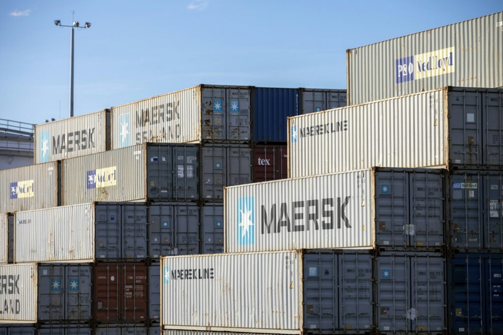 Stacked new and used shipping containers ready for delivery across Australia