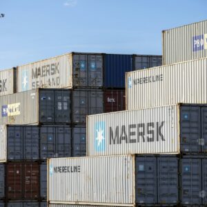 Stacked new and used shipping containers ready for delivery across Australia