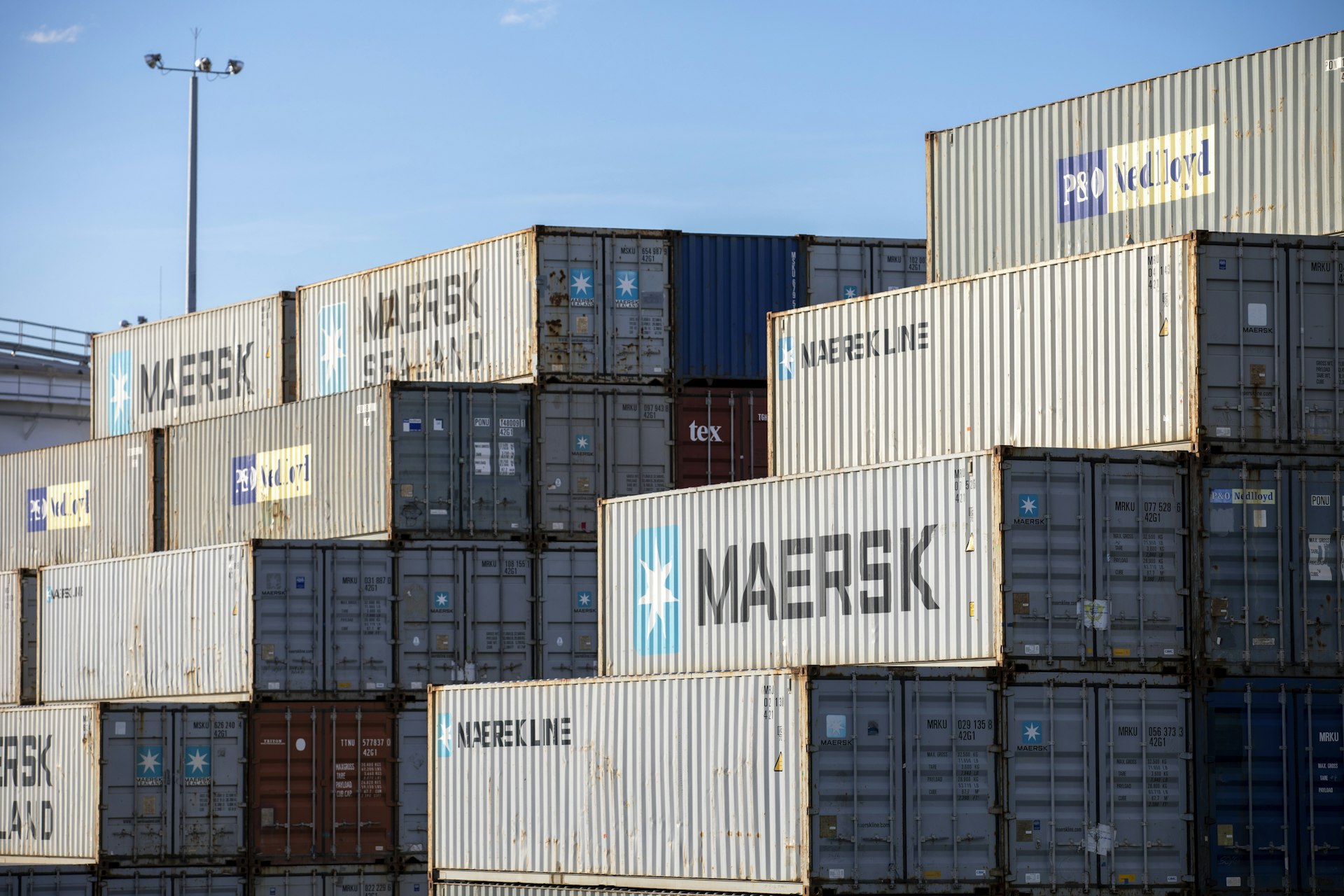Stacked new and used shipping containers ready for delivery across Australia
