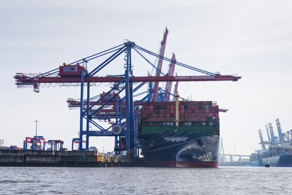 Crane loading a shipping container onto a freighter