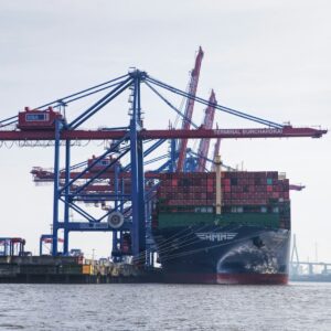 Crane loading a shipping container onto a freighter
